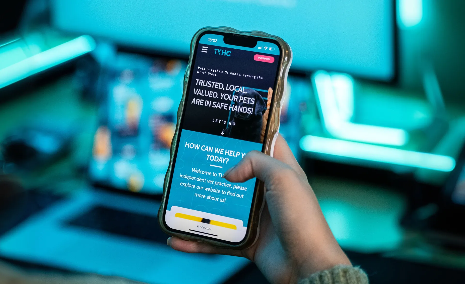 A hand holding a mobile phone showing the TVHC website homepage designed by DotPerformance, displaying the "Trusted, Local, Valued. Your pets are in safe hands" headline for The Veterinary Health Centre in Lytham St Annes